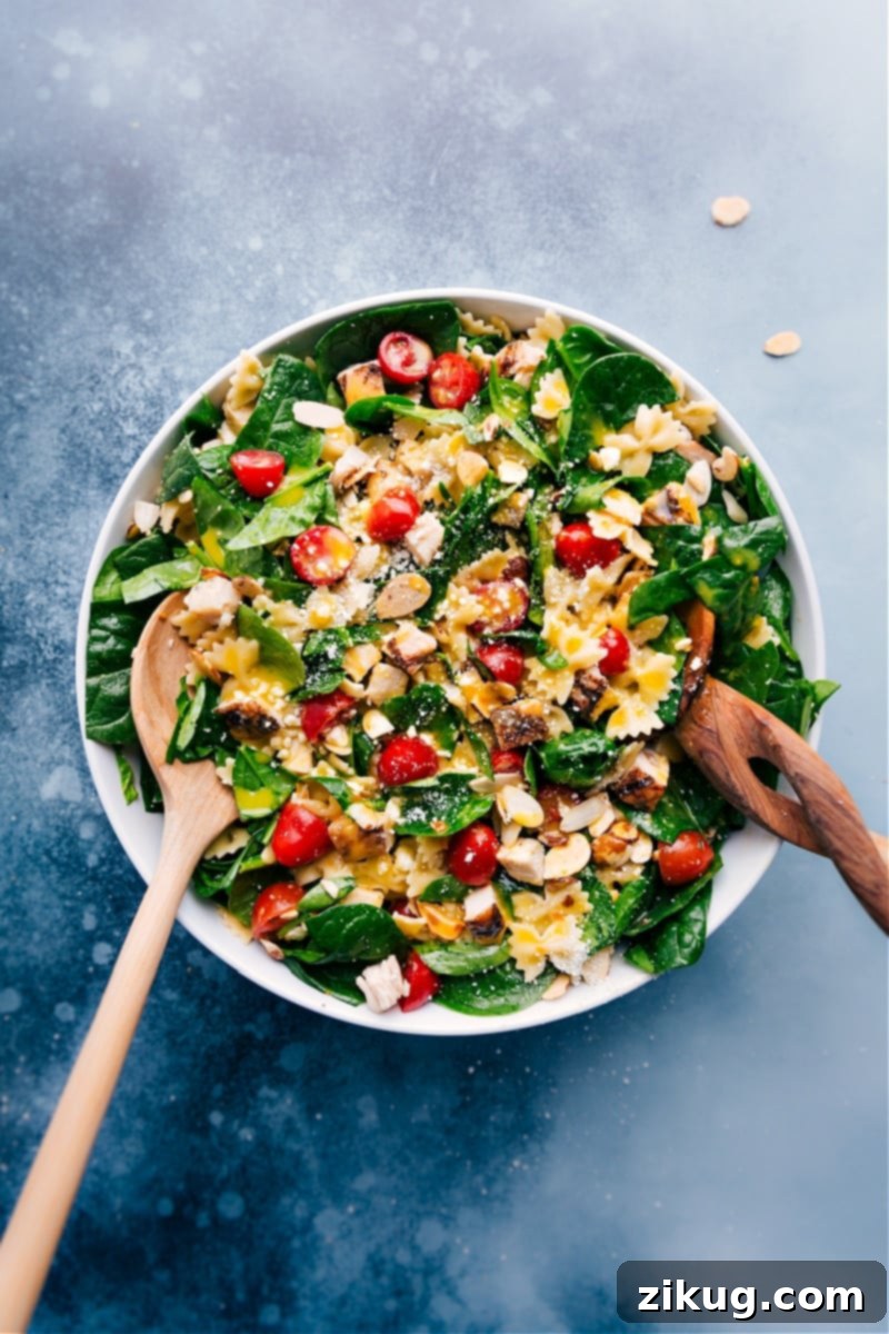 Chicken Pasta Salad: Rotisserie chicken, mini bowtie pasta, fresh veggies, and a delicious citrus vinaigrette dressing for a quick, easy, and healthy meal. Overhead image of the Chicken Pasta Salad with rotisserie chicken, mini bowtie pasta, fresh veggies and a delicious citrus vinaigrette dressing.