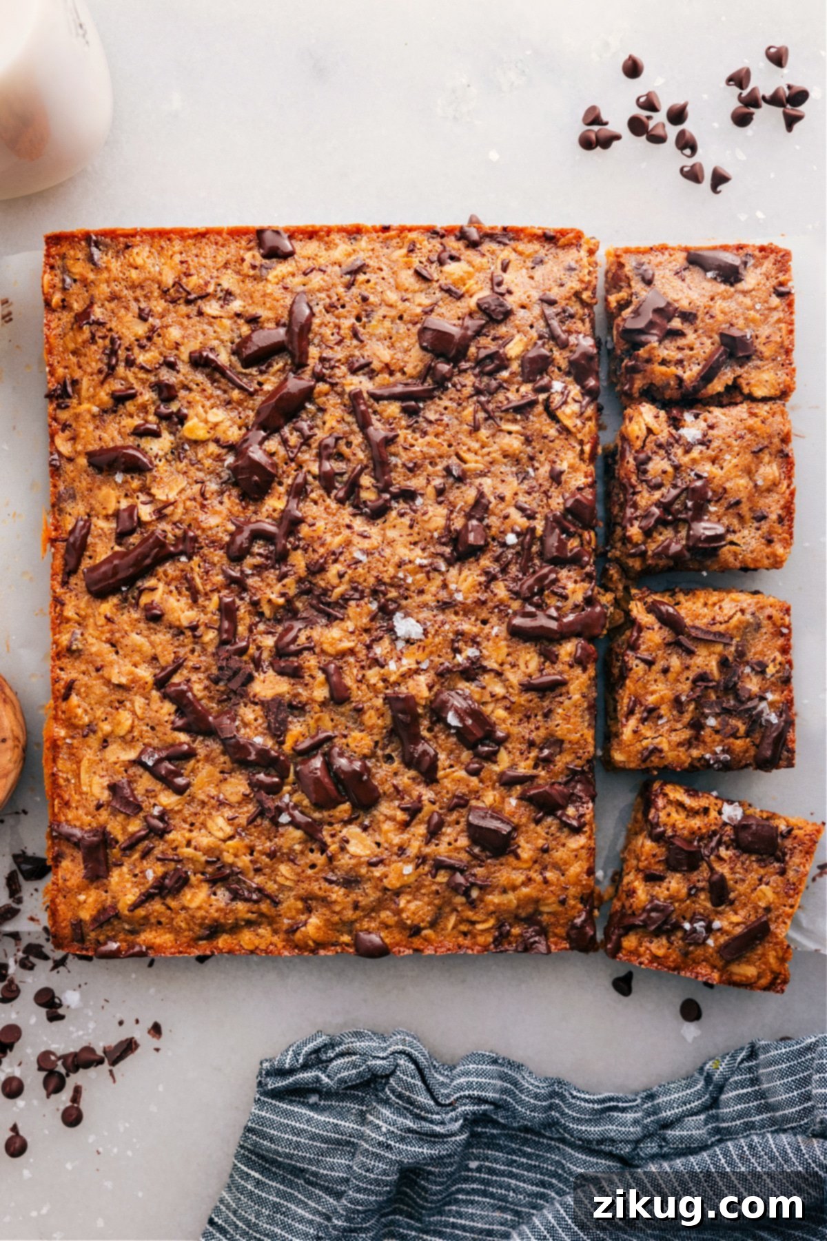 Delicious Soft-Baked Oatmeal Breakfast Bars with several squares cut and artfully topped with melted chocolate, ready to be enjoyed as a healthy snack or breakfast.