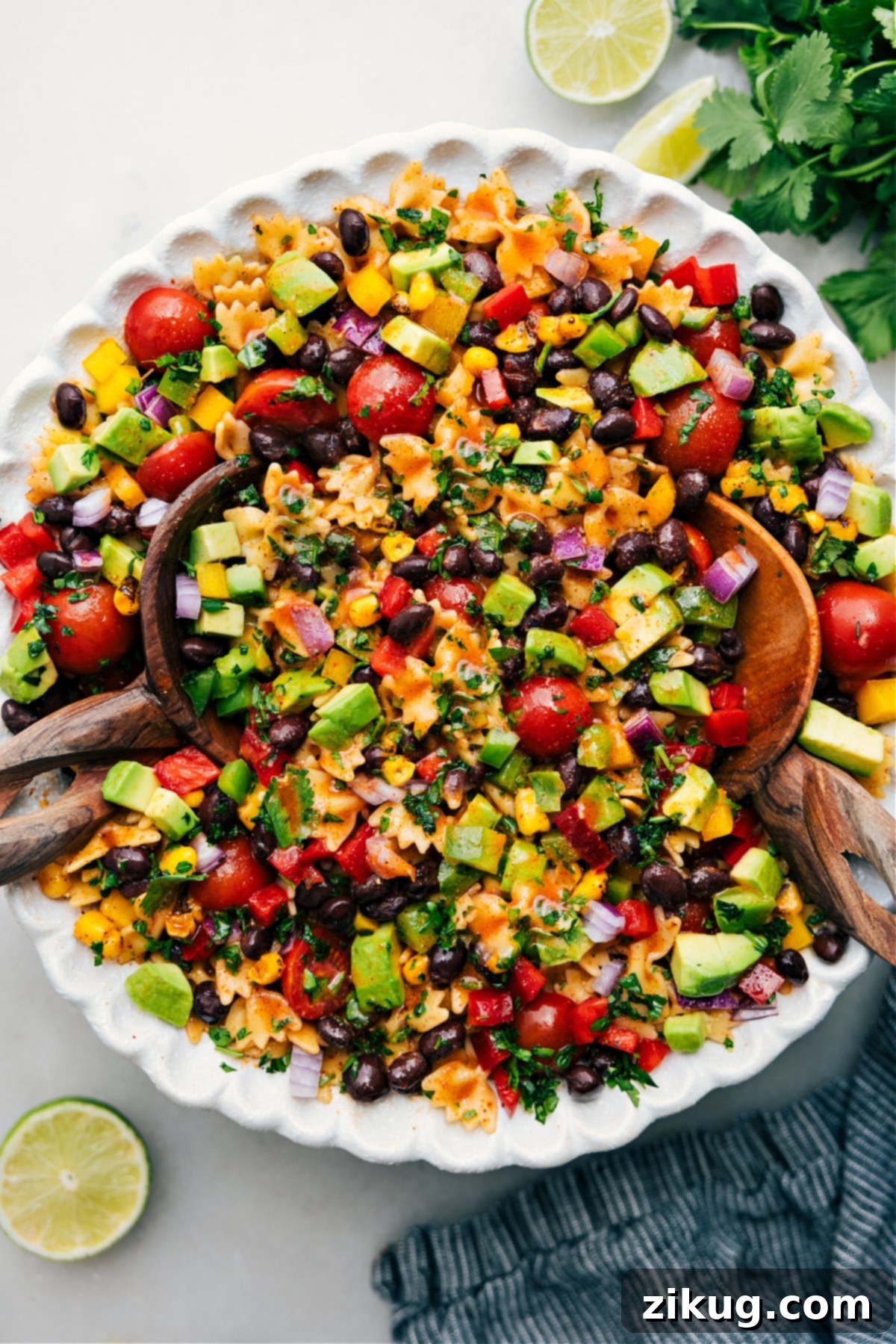 A vibrant bowl of Mexican Pasta Salad, fully dressed and ready to be served, showcasing colorful ingredients like corn, black beans, bell peppers, tomatoes, and cilantro.