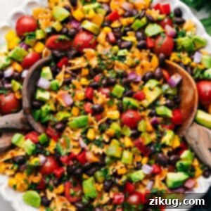 A close-up of the finished Mexican Pasta Salad, showcasing the vibrant colors and fresh ingredients coated in chili-lime dressing.