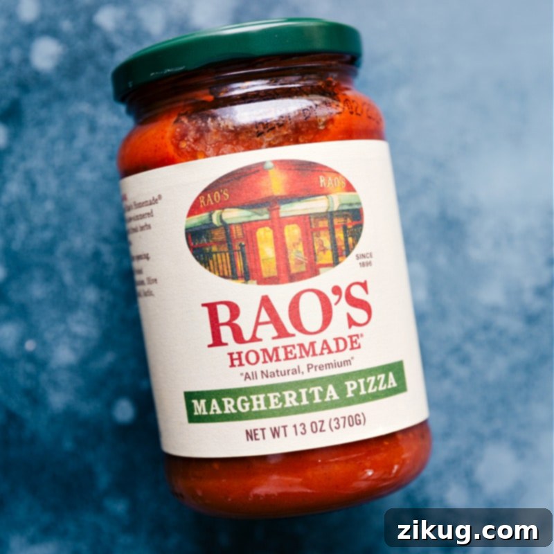 Rich, red pizza sauce spread as the base for the flatbread pizza.