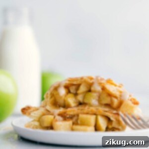 Beautifully baked apple turnovers, golden brown with flaky crusts and a sweet glaze drizzle.