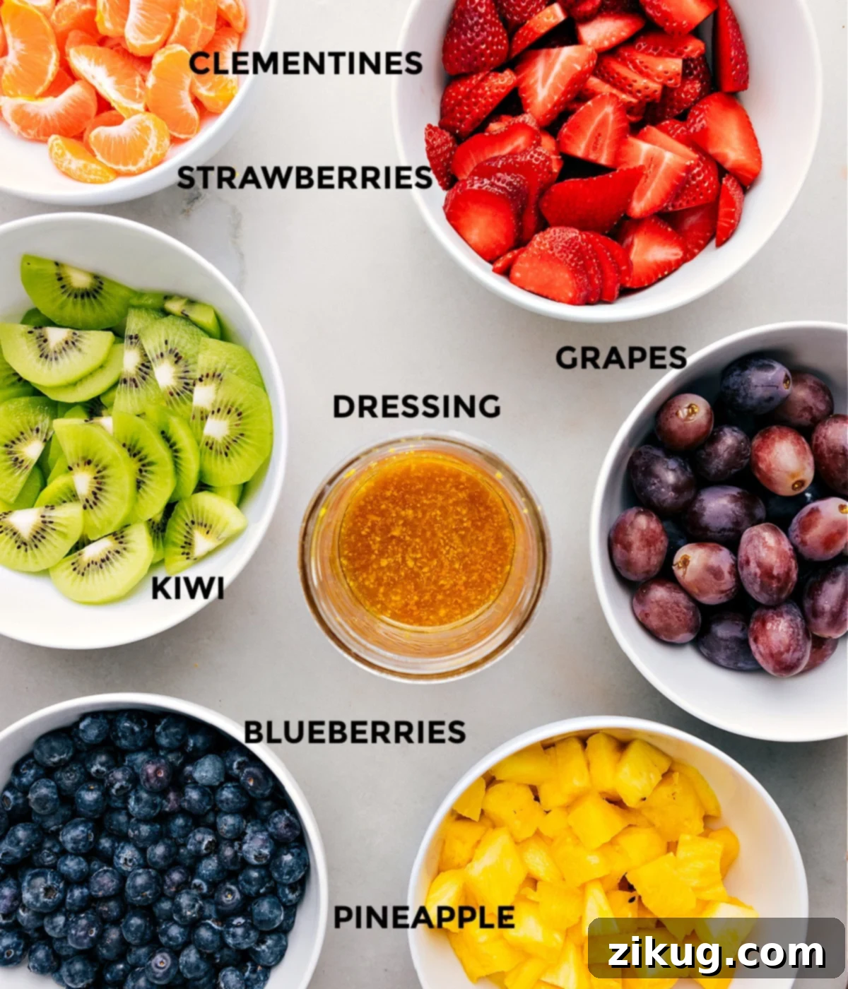 All the fresh ingredients for the fruit salad recipe prepped and laid out for easy assembly.