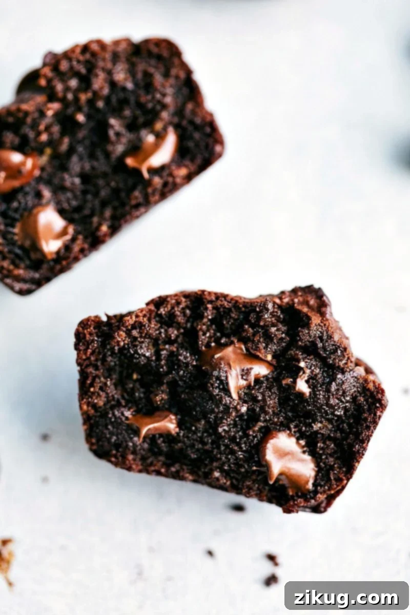Gooey Perfection: Halved Peanut Butter Chocolate Chip Muffins Halved peanut butter chocolate chip muffins with melted chocolate chips on the inside, showcasing their deliciousness.