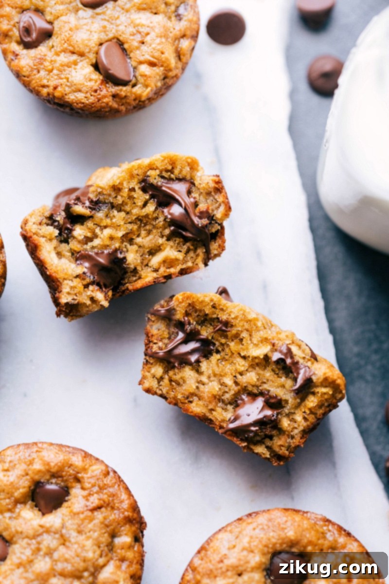 Inside View of a Peanut Butter Banana Muffin with Melting Chocolate Chips Peanut butter banana muffin broken open, revealing the delicious interior with melting chocolate chips.