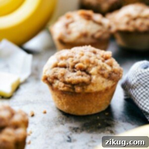A freshly baked banana crumb muffin with a perfect golden crust and cinnamon streusel topping, ready to be served.