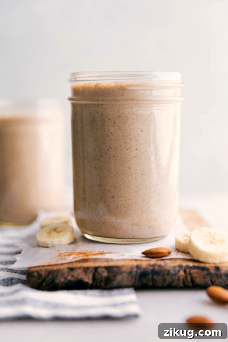 Refreshing Banana Smoothie in Minutes A glass of banana smoothie with a straw, placed on a wooden surface, ready to be enjoyed as a refreshing and healthy drink.