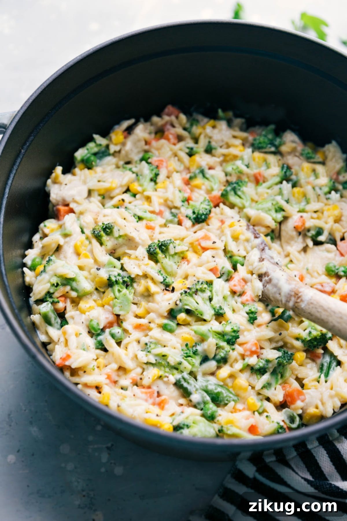Creamy Orzo in a large pot, garnished and ready to serve, highlighting its rich, creamy texture and vibrant vegetables.