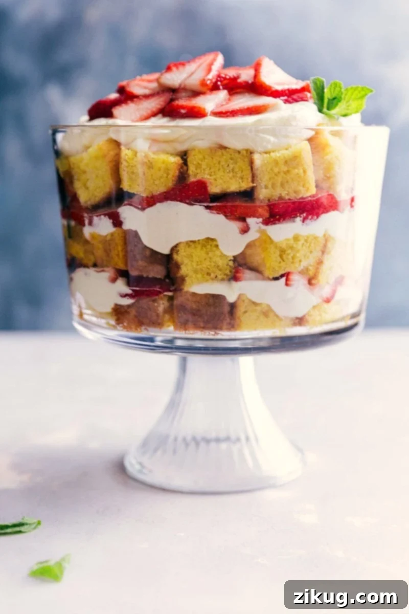 Layers of homemade vanilla cake, fresh sliced strawberries, and luscious vanilla cream in a glass trifle dish.