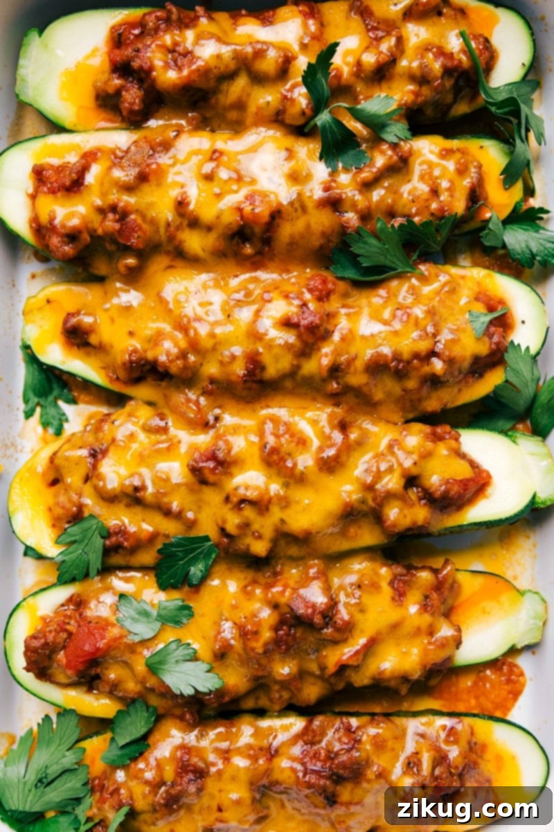 Mouthwatering Zucchini Boats with Melted Cheese - Just Baked Zucchini boats fresh out of the oven, topped with melted cheese, showcasing the finished recipe.