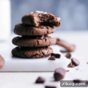 Healthy chocolate chip cookies stacked with a bite out of one of them.