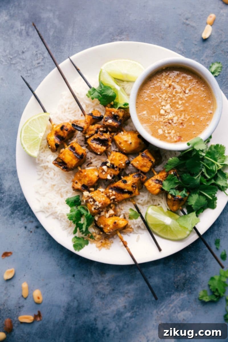 Delectable Peanut Sauce Chicken Skewers with a Side of Peanut Sauce Skewers of peanut sauce chicken, artfully presented on a plate with a side of luscious peanut sauce, garnished with fresh cilantro.