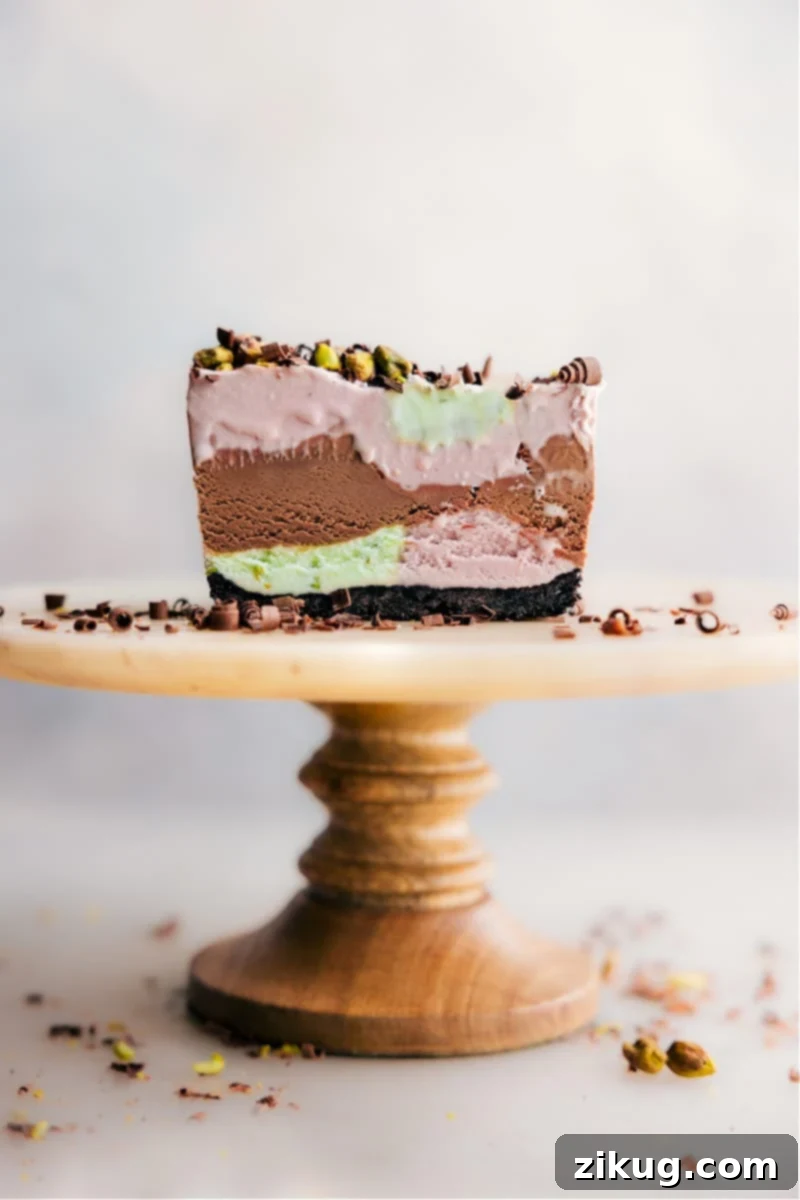 Homemade Spumoni Ice Cream with cherry, chocolate, and pistachio layers. Sliced Spumoni Ice Cream Bars on a cake stand, showcasing distinct layers of cherry, chocolate, and pistachio ice cream.