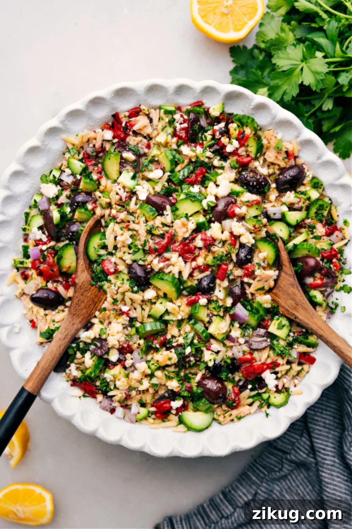 A beautifully tossed and dressed Mediterranean Tuna Salad in a large bowl, showcasing fresh ingredients and vibrant colors.