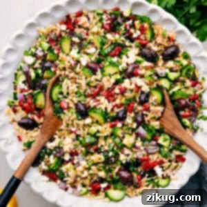 A vibrant bowl of Mediterranean Tuna Orzo Salad, showcasing tender orzo, flaked tuna, and colorful fresh vegetables, ready to be served.