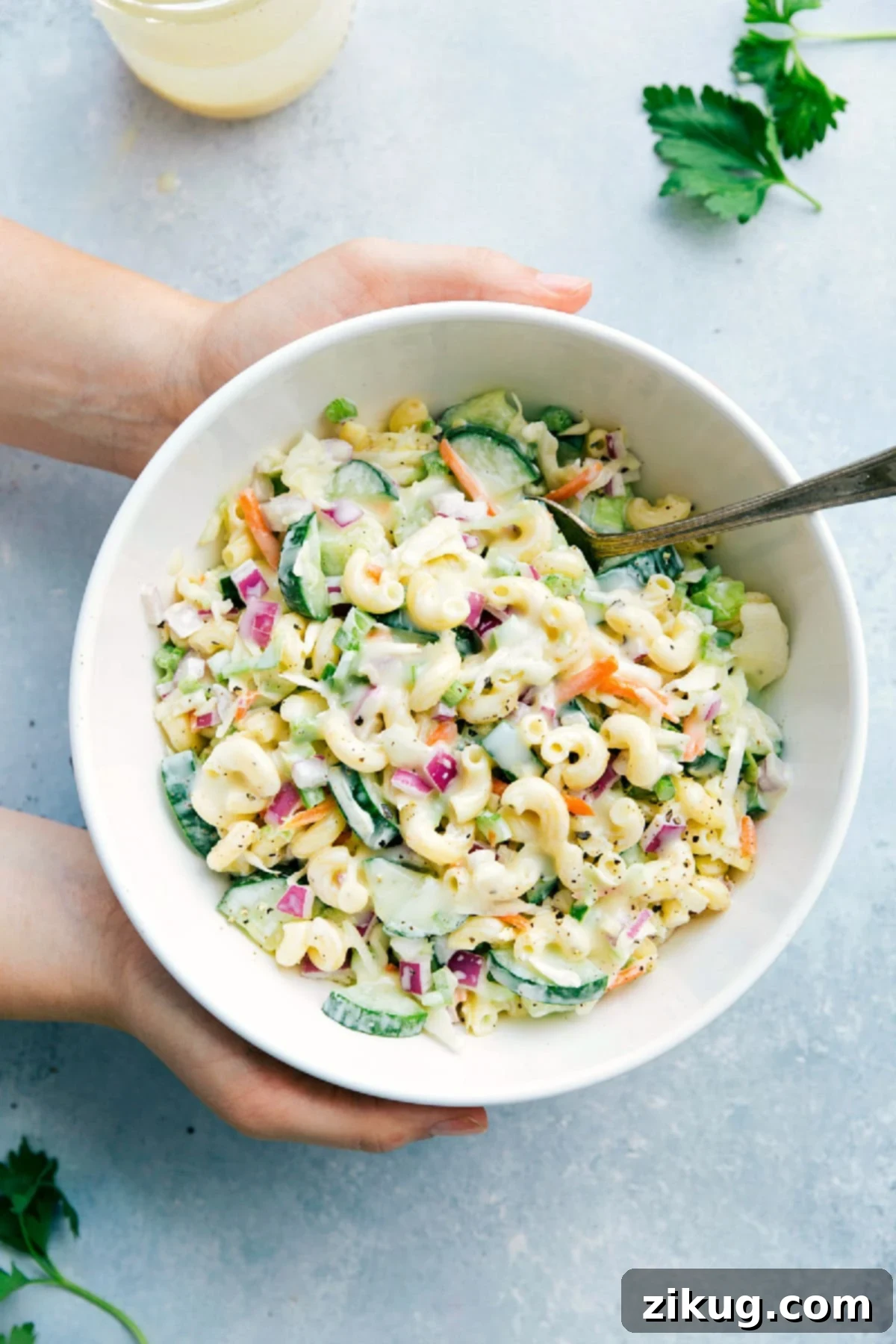 A vibrant bowl of Macaroni Coleslaw Salad, featuring creamy pasta, crisp cabbage, and colorful vegetables, ready to be served and enjoyed.
