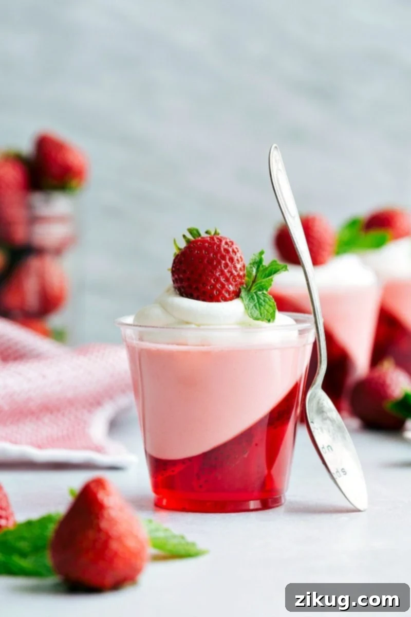 Five simple ingredients create these stunning double-layered strawberry Jello parfait cups, featuring an innovative slanted Jello layer and a light strawberry mousse.