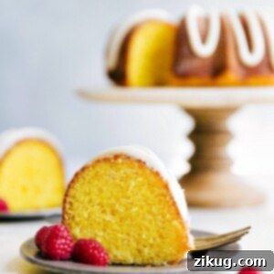 A beautifully decorated lemon bundt cake, generously frosted with lemon buttercream, ready for serving.