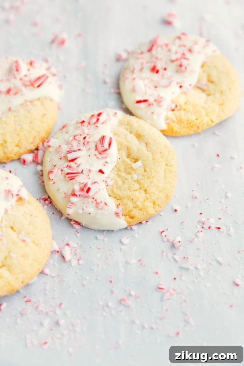Delicious 3-ingredient White Chocolate Peppermint Christmas cookies! PLUS two free printables to festively package up these cookies! Recipe via chelseasmessyapron #holidays #chocolate #best #quick #easy #simple #3ingredients #christmas #cookies Overhead image of the white chocolate peppermint cookies on a cooling rack
