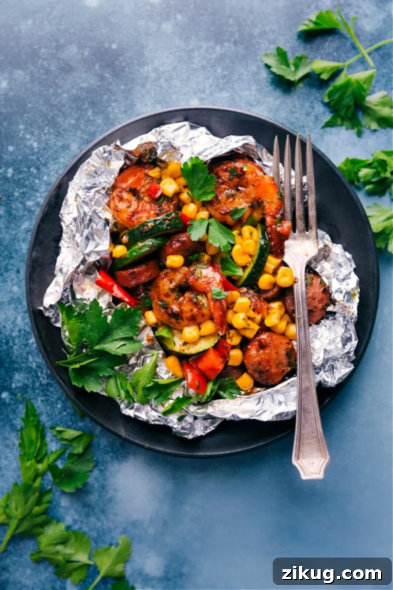 Effortless Shrimp Foil Packets: a complete meal with seasoned shrimp, smoked sausage, and fresh vegetables, ready for grill, oven, or campfire. Delicious Shrimp Foil Packets with sausage and colorful vegetables ready for cooking