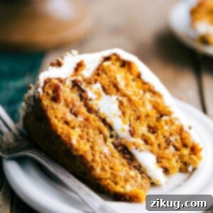 Delicious Slice of Pumpkin Carrot Cake Slice of pumpkin carrot cake revealing its soft and moist interior, topped with a delicious icing.