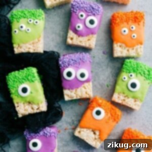 Vibrant green monster Rice Krispies Treat with multiple candy eyeballs, ready for Halloween fun.
