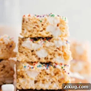 Rice Krispie Treats squares stacked showing gooey texture.