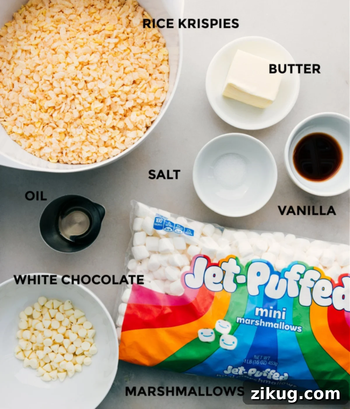 All the ingredients including cereal, butter, vanilla, salt, oil, white chocolate, and marshmallows in this recipe prepped out for easy assembly.