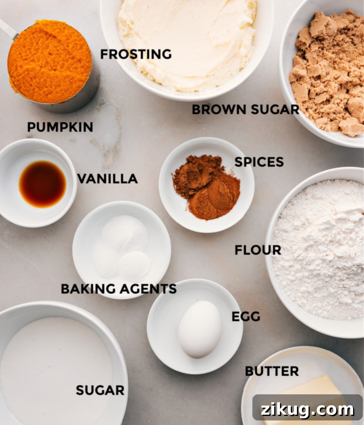 Ingredients In Pumpkin Cookies With Cream Cheese Frosting This recipe's ingredients—sugar, spices, flour, baking agents, egg, butter, vanilla, and pumpkin—are prepped for easy assembly.