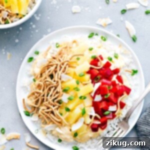 Creamy Chicken Hawaiian Haystacks with a vibrant assortment of fresh toppings including pineapple, olives, and green onions.
