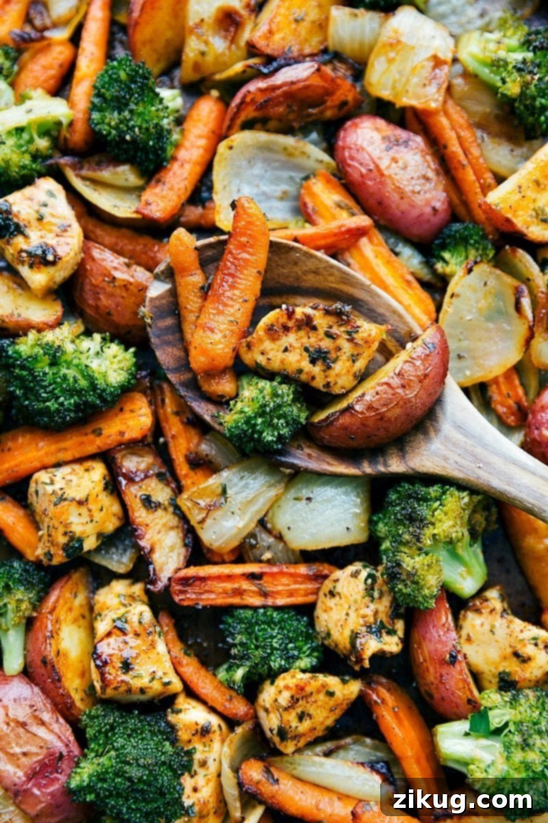 Easy One Pan Roasted Chicken And Vegetables Recipe for Healthy Meal Prep A beautifully arranged sheet pan of roasted chicken and mixed vegetables seasoned with garlic and Parmesan.