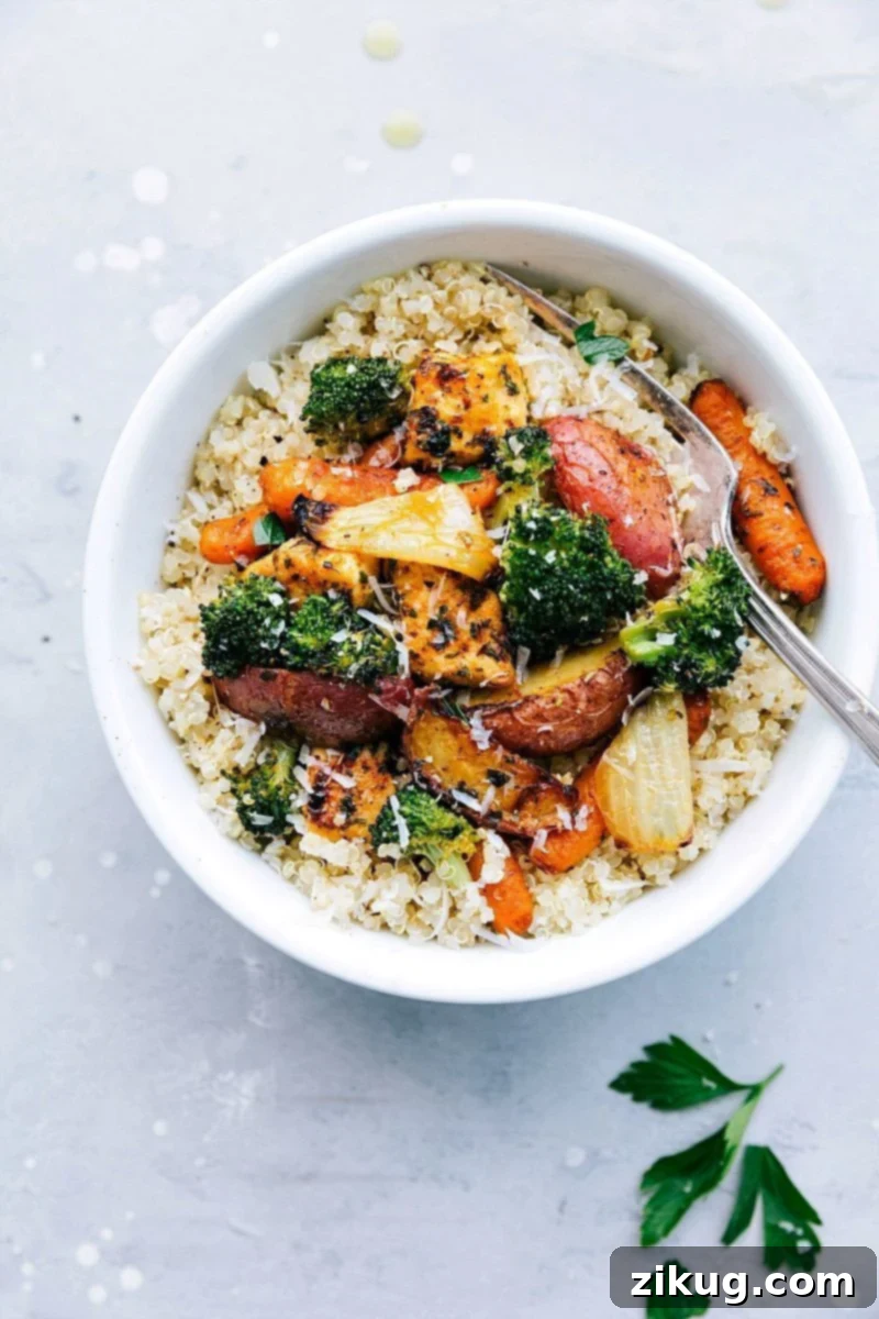 Meal Prep Perfection: Roasted Chicken And Vegetables Served Over Quinoa Healthy roasted chicken and vegetables portioned over quinoa in meal prep containers.