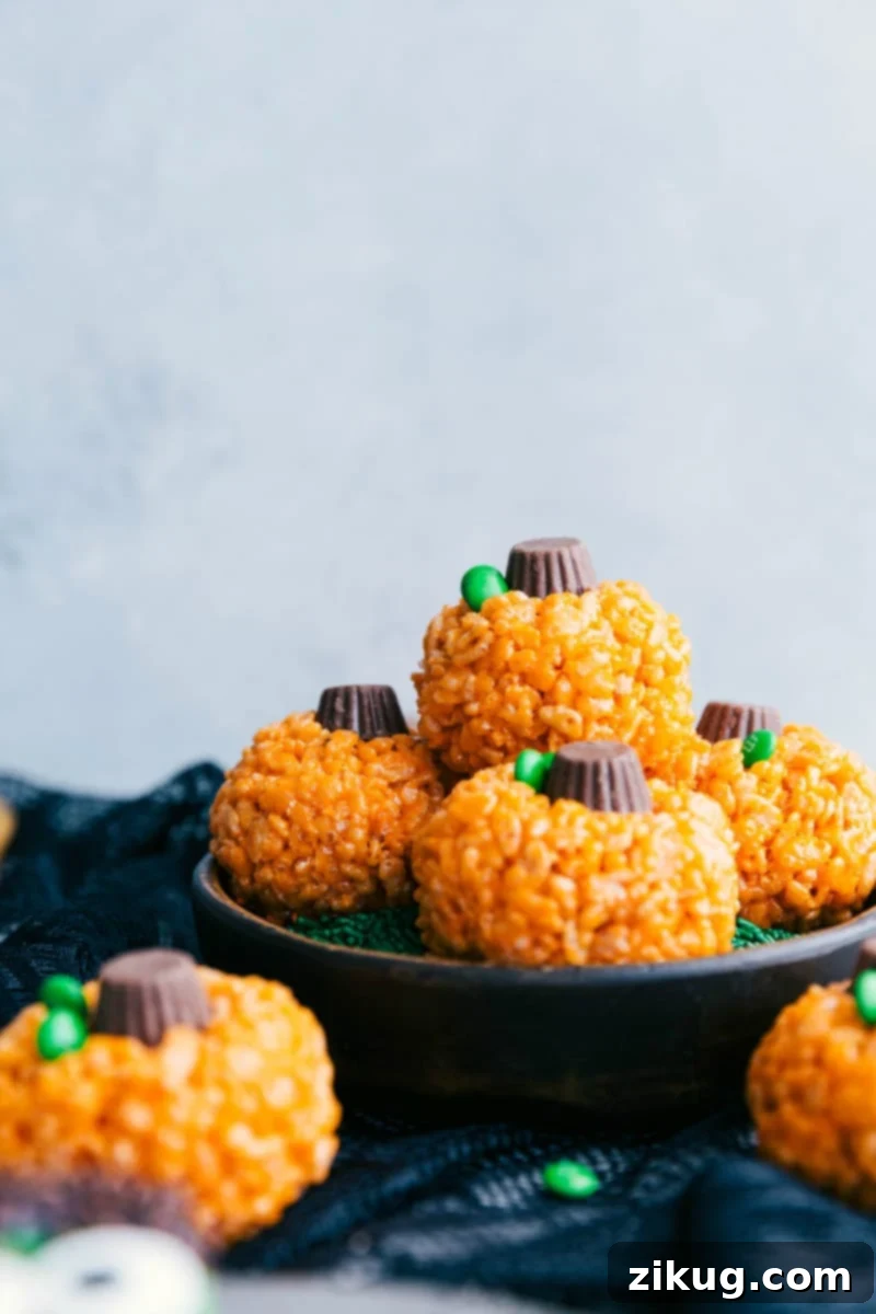 Image of the pumpkin krispies treats stacked on top of each other, complementing other Halloween rice krispie treats