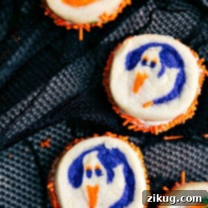 Double-sided Halloween sandwich cookies featuring ghost and pumpkin designs.
