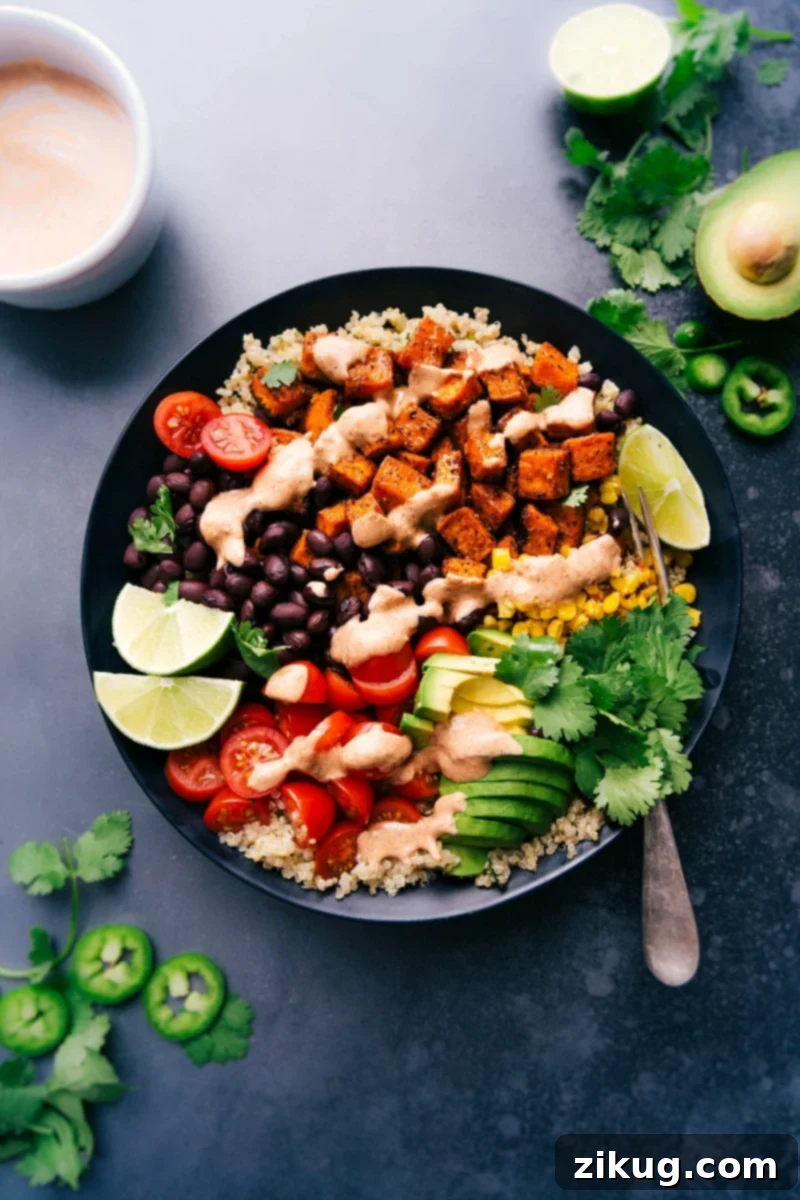 Sweet Potato Power Bowl 3 A beautifully presented sweet potato taco bowl, loaded with fresh ingredients and a zesty sauce, ready to be enjoyed.