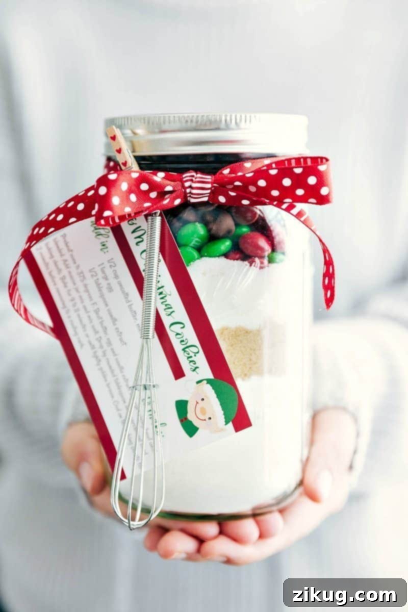 Beautifully layered M&M Mason Jar Cookies with a free printable recipe tag, ready to be gifted for Christmas.