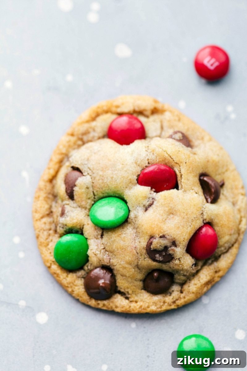 Baked M&M Mason Jar Cookies, golden brown and packed with colorful chocolate candies, cooling on a rack.