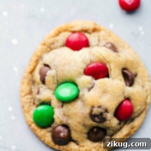 A baked M&M cookie, perfectly golden with melted chocolate chips and colorful M&Ms.