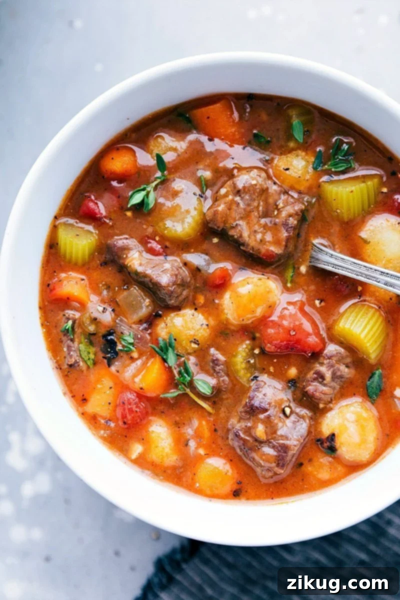 Crockpot Beef Stew With Gnocchi For A Twist A hearty bowl of Slow Cooker Beef Stew with Gnocchi, brimming with tender beef, vibrant carrots, and rich gravy, ready to be savored.