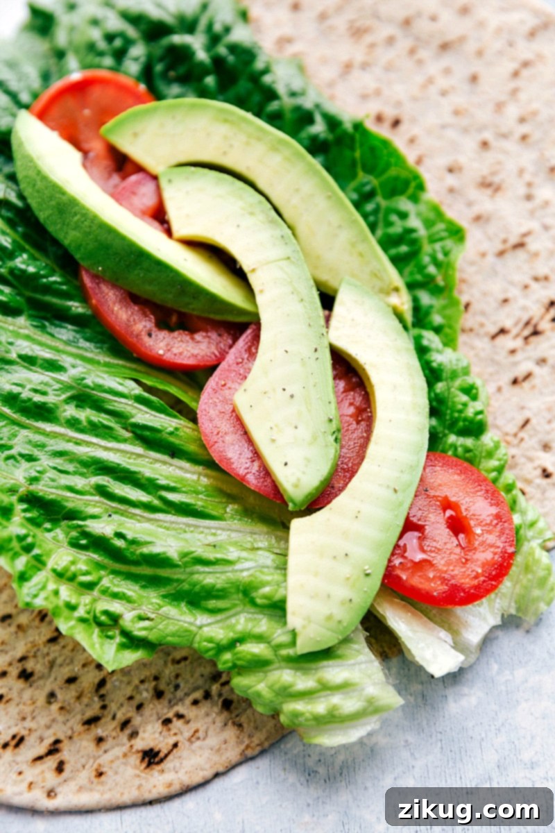 Our absolute favorite chicken salad Tortilla with lettuce, tomatoes, and avocado on it for Chicken Salad Wraps.