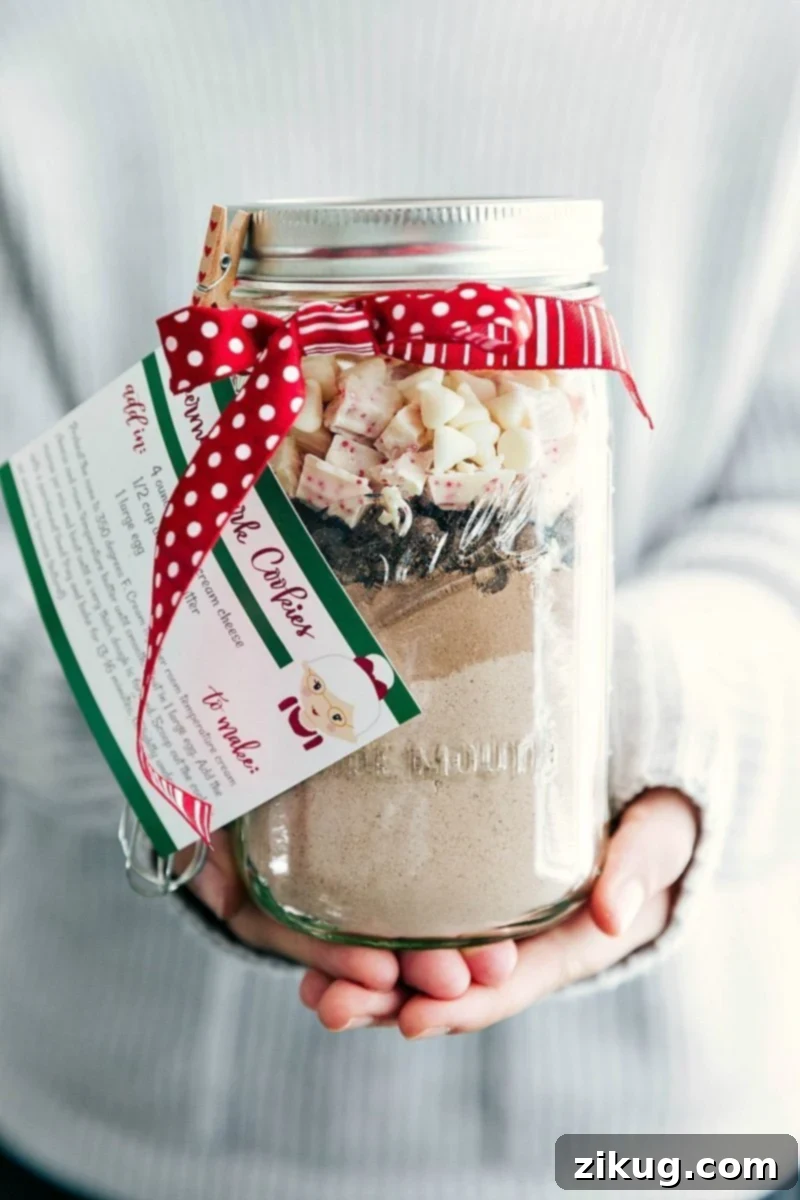 Mason Jar Peppermint Cookies - Perfect Holiday Gift Beautifully layered Mason Jar Peppermint Cookies mix with a festive ribbon and the free printable recipe attached.