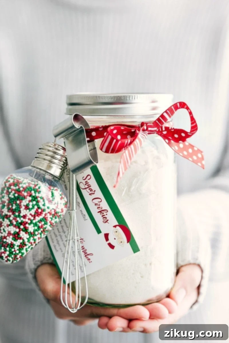 Homemade Mason Jar Sugar Cookies 2 Beautifully decorated Christmas sugar cookies presented in a clear mason jar with a ribbon and tag, perfect for a holiday gift.