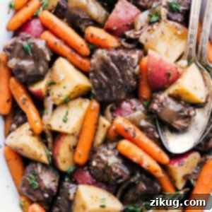 A delicious crockpot roast recipe, ready to be served, topped with fresh herbs.