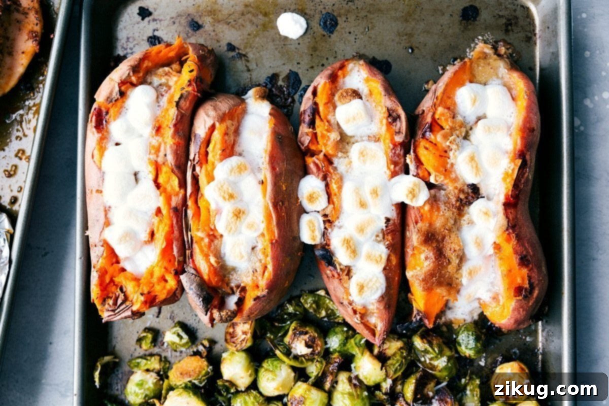 Perfectly Browned Marshmallow-Topped Candied Sweet Potatoes on Sheet Pan Candied sweet potatoes on a sheet pan with perfectly browned marshmallows, ready to serve.