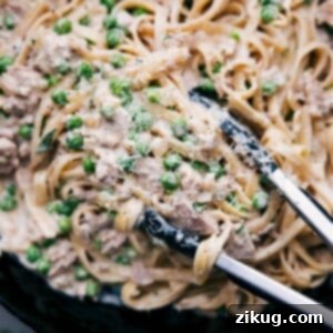 Close-up of a serving of Creamy Tuna Pasta, garnished with fresh herbs