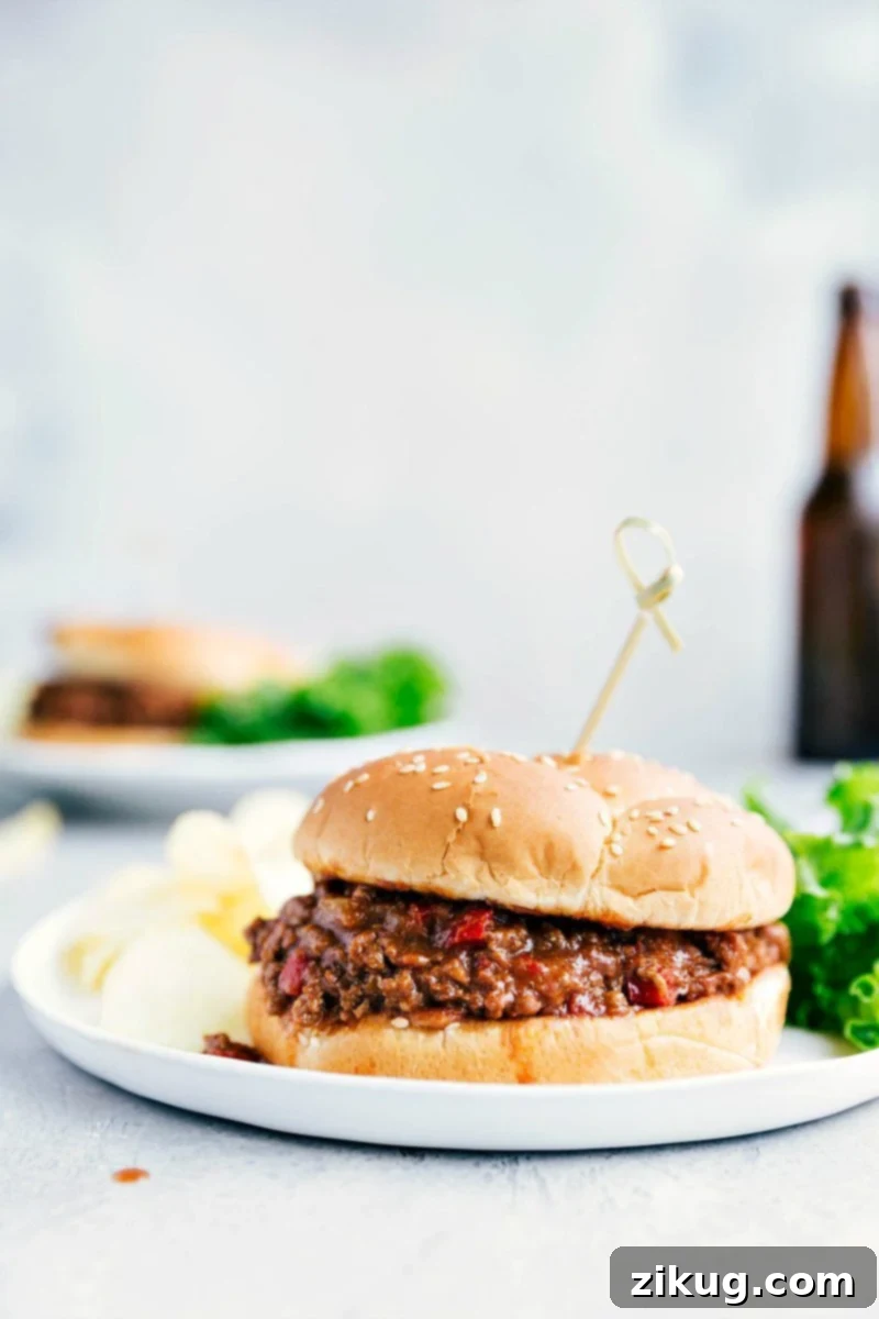 Our favorite Crockpot Sloppy Joes! The slow cooker makes the meat filling ultra-tender and deeply flavorful. We load that savory and slightly sweet meat filling onto toasted brioche buns for a dinner people won't be able to stop raving about! These sandwiches are great to serve to a crowd and perfect for summer BBQs or game-day eating. Delicious Crockpot Sloppy Joes on a plate, ready to be served on toasted brioche buns