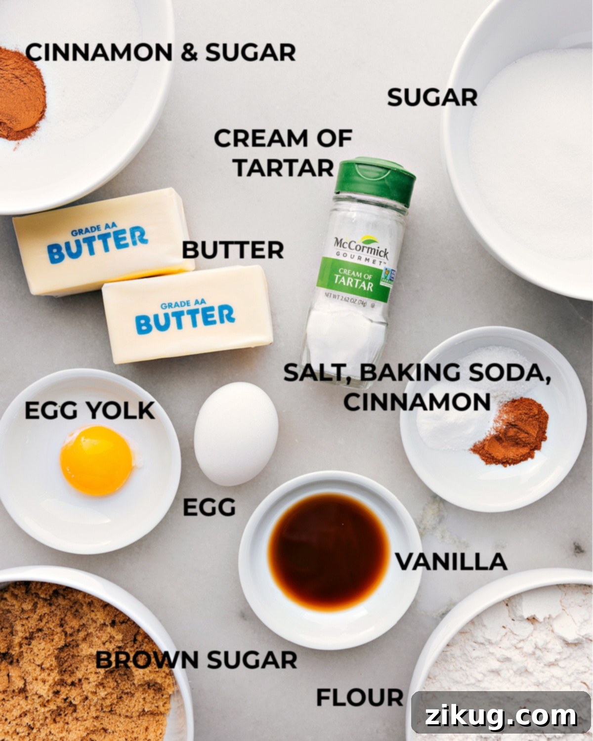 Snickerdoodle Cookie Ingredients Various ingredients for making the snickerdoodle recipe arranged on a kitchen counter, including flour, sugar, eggs, and cinnamon.
