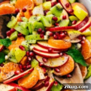 Winter Fruit Salad with fresh, juicy fruits like clementines, pomegranate, apples, kiwi, and pears, all mixed in a simple poppy seed dressing.