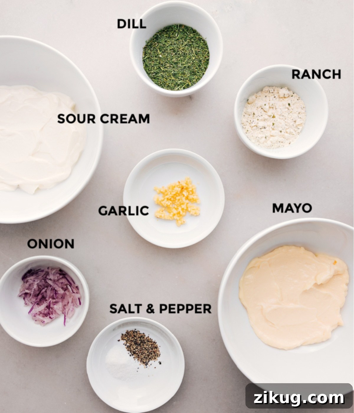 Key Ingredients for Delicious Veggie Ranch Dip A selection of fresh ingredients laid out, including sour cream, mayonnaise, ranch seasoning mix, grated red onion, minced garlic, fresh dill, salt, and pepper, ready to be combined for a delicious veggie dip.