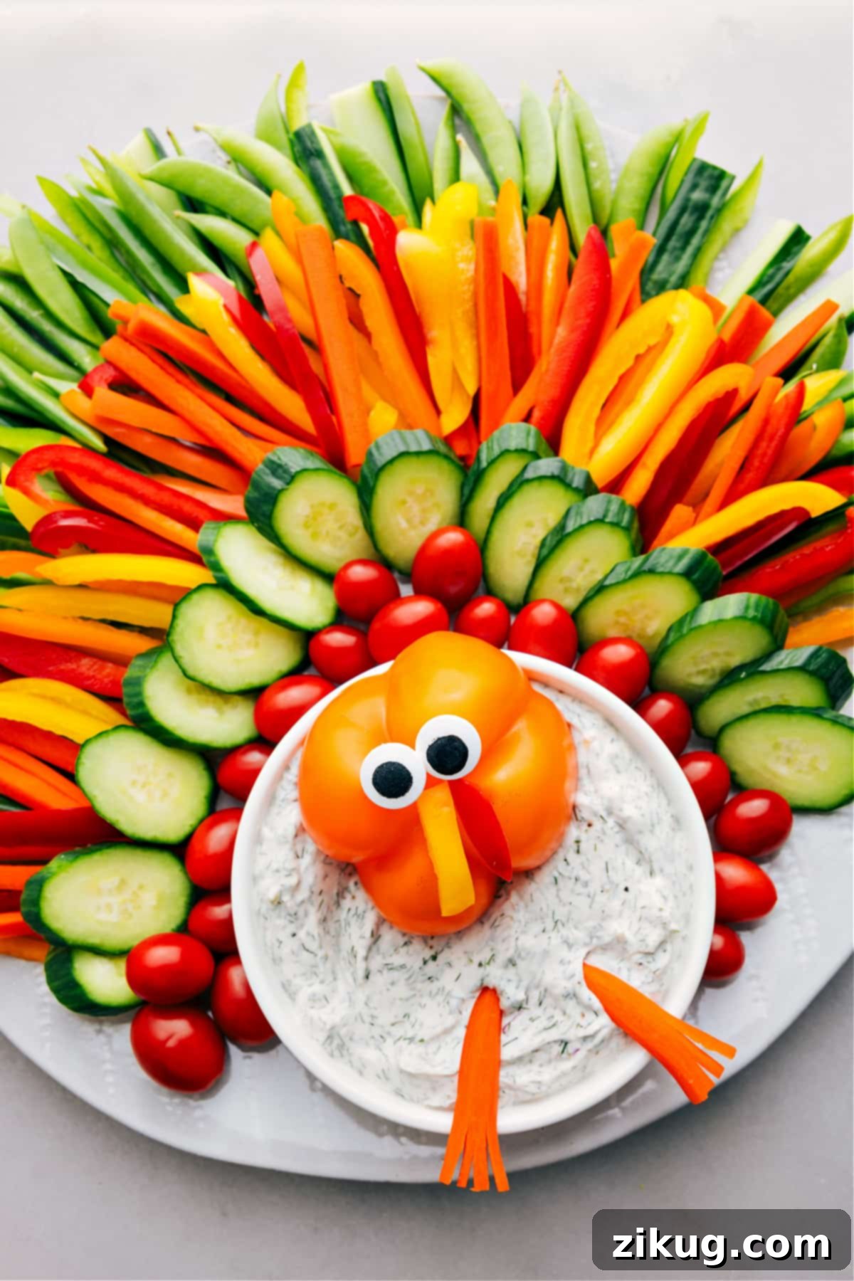 Creative Turkey Veggie Dip Recipe for Thanksgiving A festive Thanksgiving appetizer: fresh vegetables creatively arranged to resemble a turkey, with a bowl of homemade dip as its body.